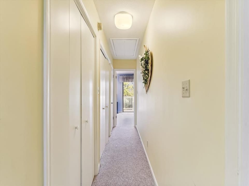 The well-designed hallway connects the thoughtful layout of the condo, enhancing accessibility to the private deck.