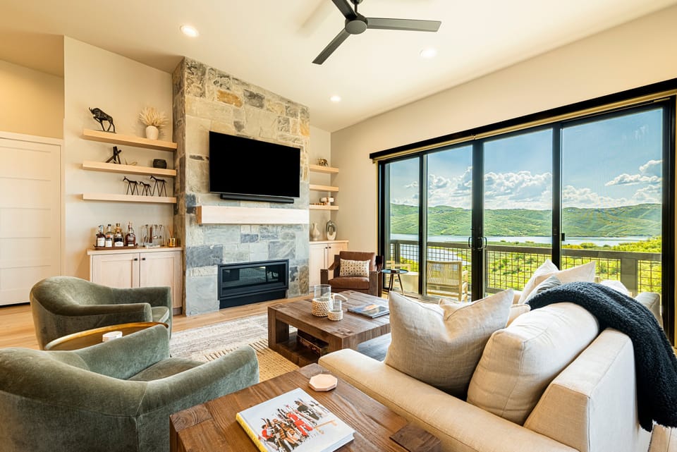Open Layout Main Level Living Area with 60" Smart TV, Gas Fireplace, and Lots of Windows with Remote Blinds throughout.
