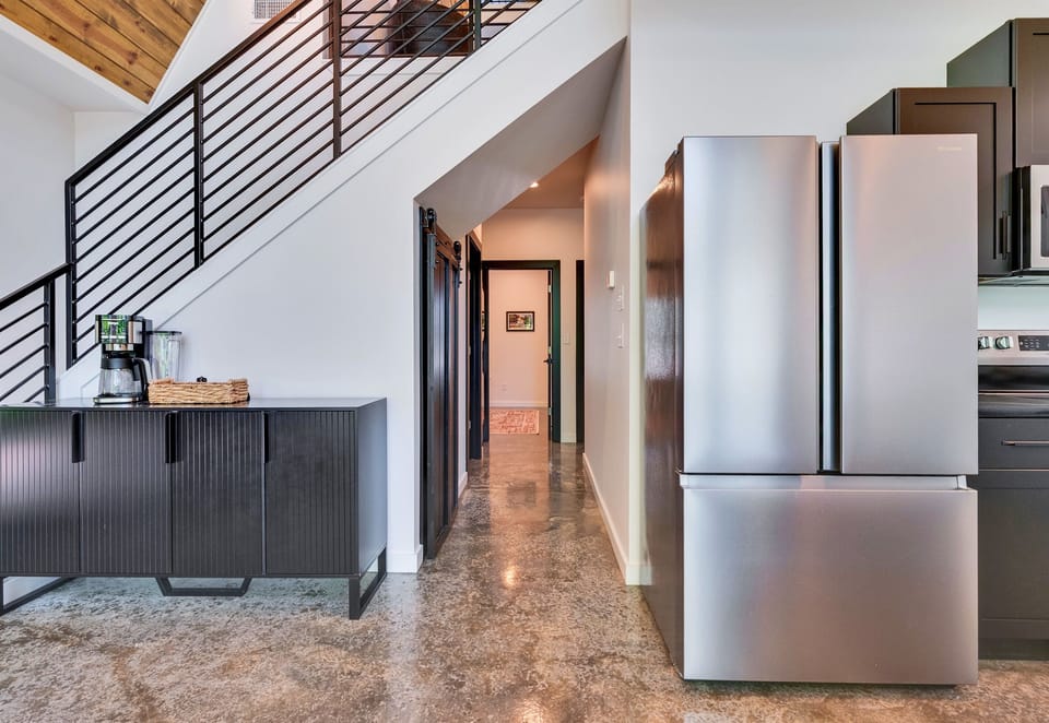 Clean lines, soft lighting, and a natural flow give this hallway a bright, inviting feel as it leads you from one space to the next.