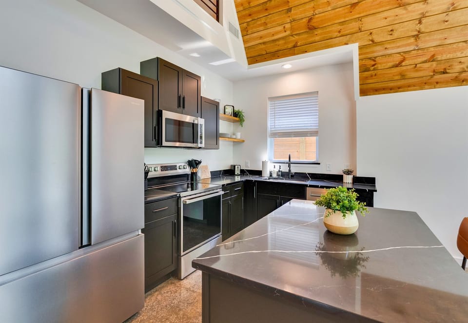 This modern kitchen has everything you need—from full-size appliances to a spacious island that invites cooking, snacking, and hanging out all in one spot.