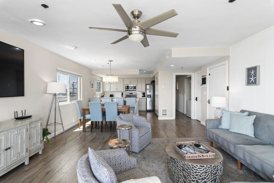 Open-concept kitchen and dining area designed for gathering and entertaining, featuring modern appliances, a spacious dining table, and plenty of natural light, perfect for cooking meals and enjoying time together.