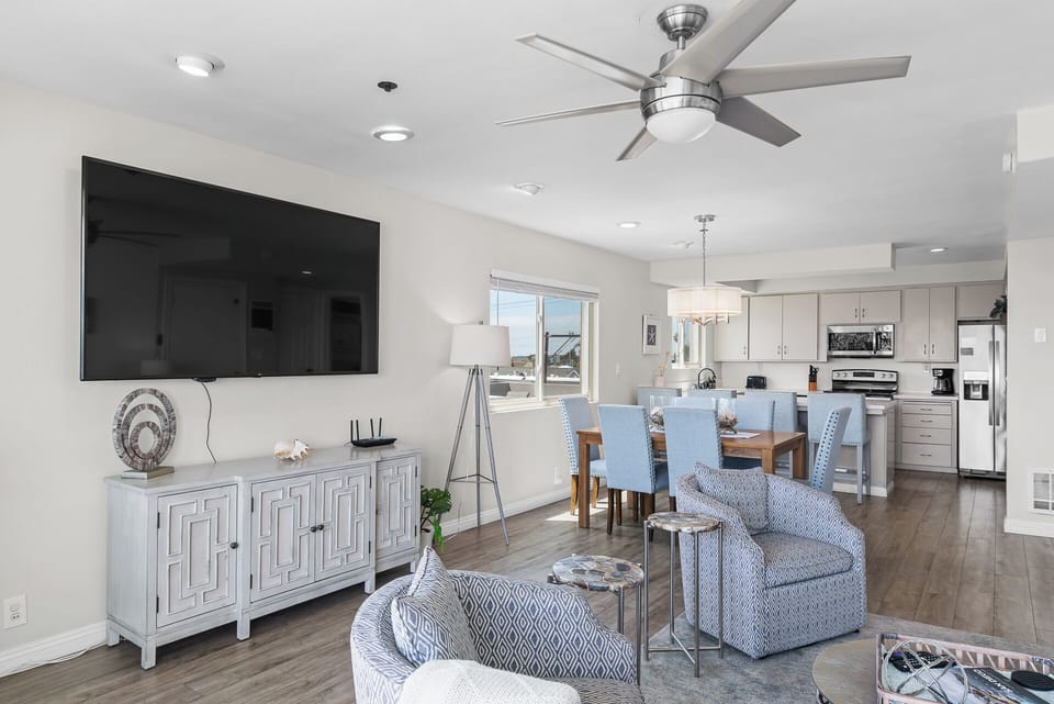 Open-concept kitchen and dining area designed for gathering and entertaining, featuring modern appliances, a spacious dining table, and plenty of natural light, perfect for cooking meals and enjoying time together.