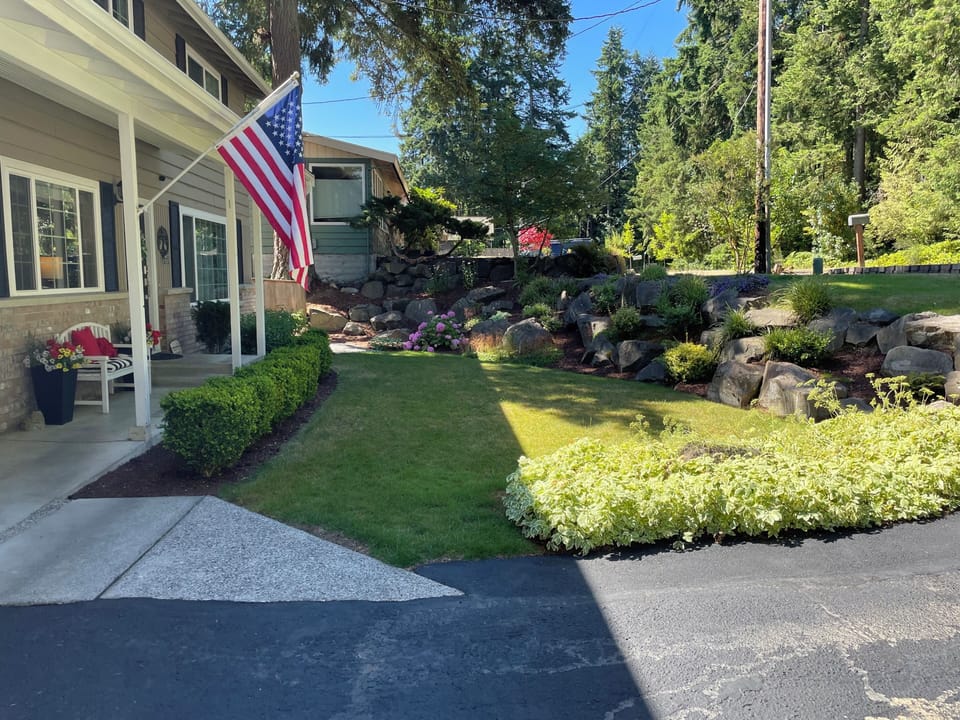 Beautiful landscaping surrounded by towering cedar and evergreen trees