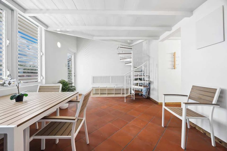 Bright and spacious dining room. This inviting dining area offers ample natural light and a comfortable setting for enjoying meals. 