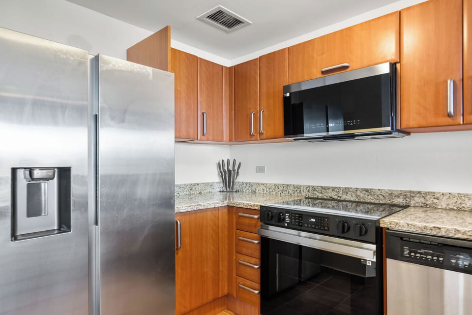 kitchen with microwave, fridge, stove, oven, utensils, cabinets