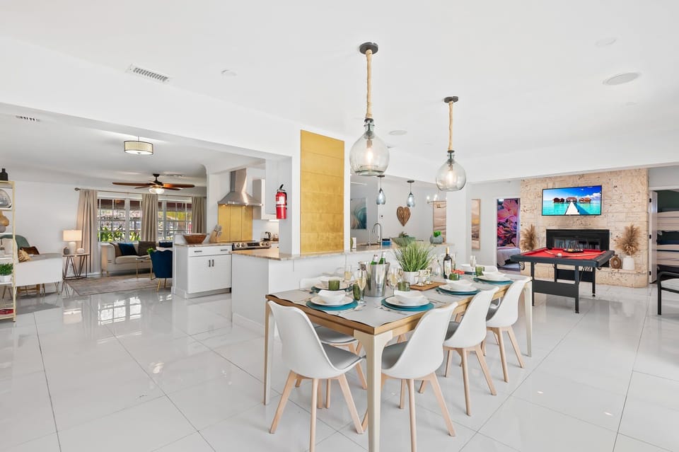 Spacious open-concept layout featuring a modern kitchen, elegant dining area, and entertainment with a pool table—perfect for cooking, dining, and relaxing together. #AirbnbHome #FamilyVacation #ModernLiving