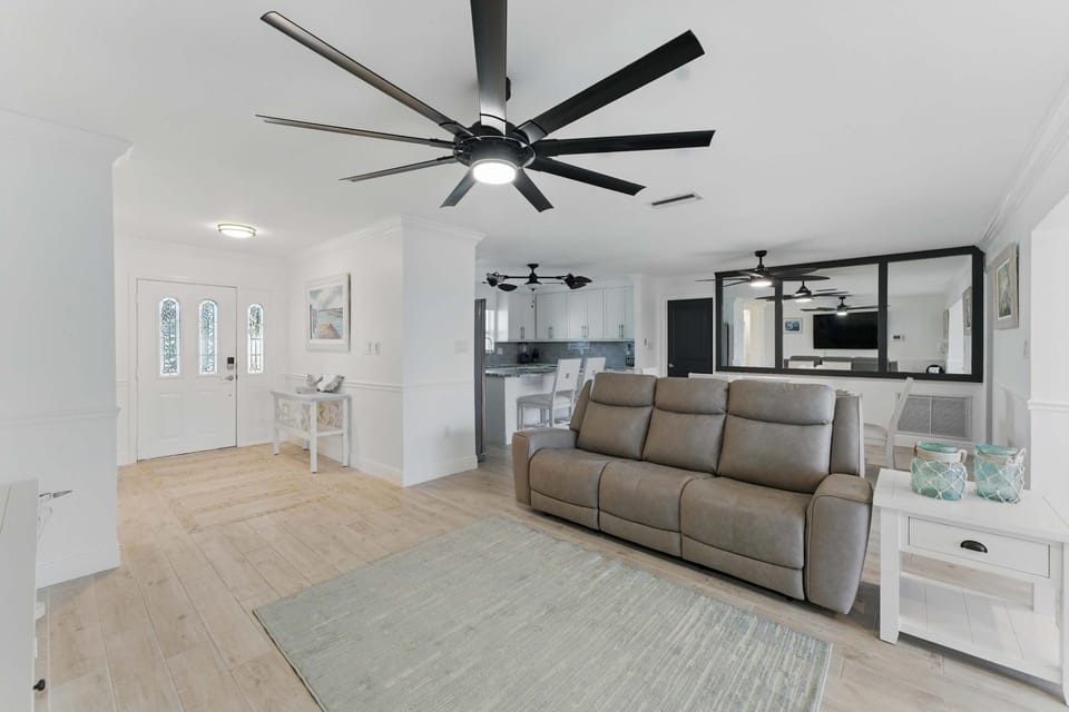 Relax in the roomy, inviting living area featuring a comfortable, wide couch perfect for lounging after a day of adventure. 