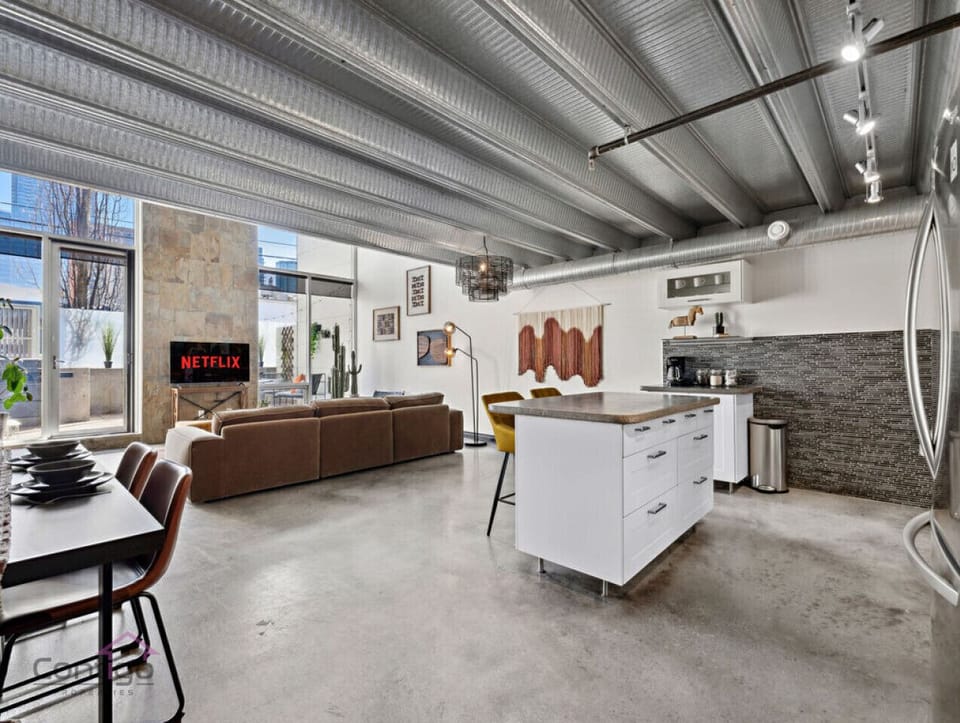 Unwind and entertain in this inviting loft, complete with a comfortable living room setup and a TV.