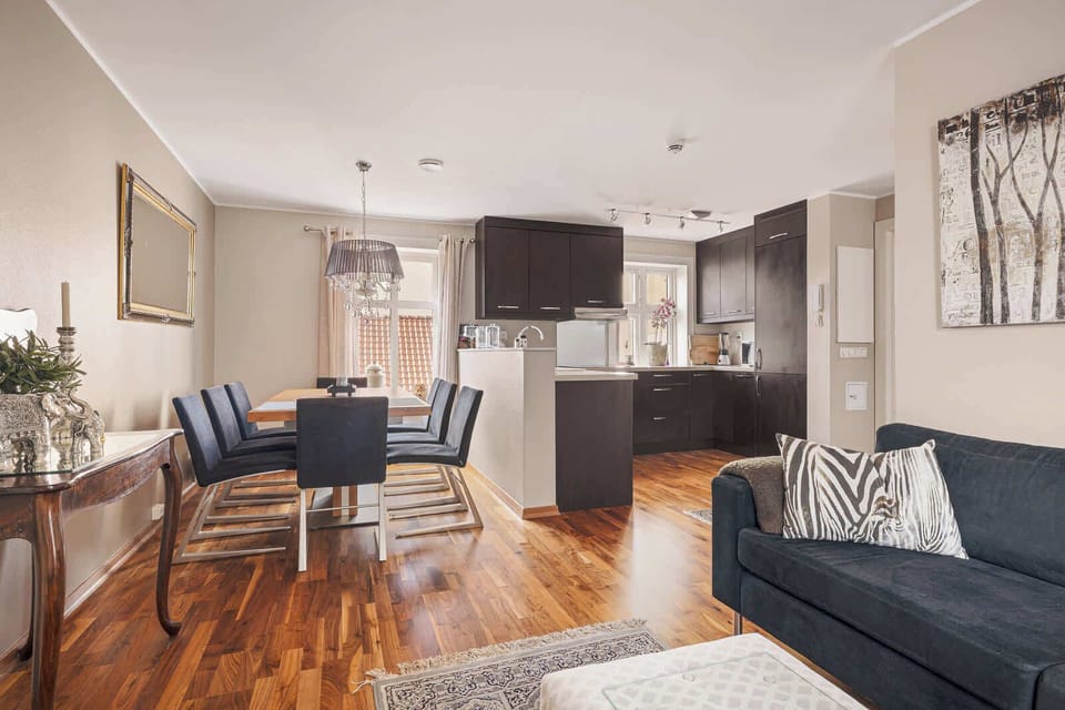 Welcome to a living room that balances style and functionality. With a plush couch and a dining table perfect for entertaining, this space is designed for both comfort and connection.