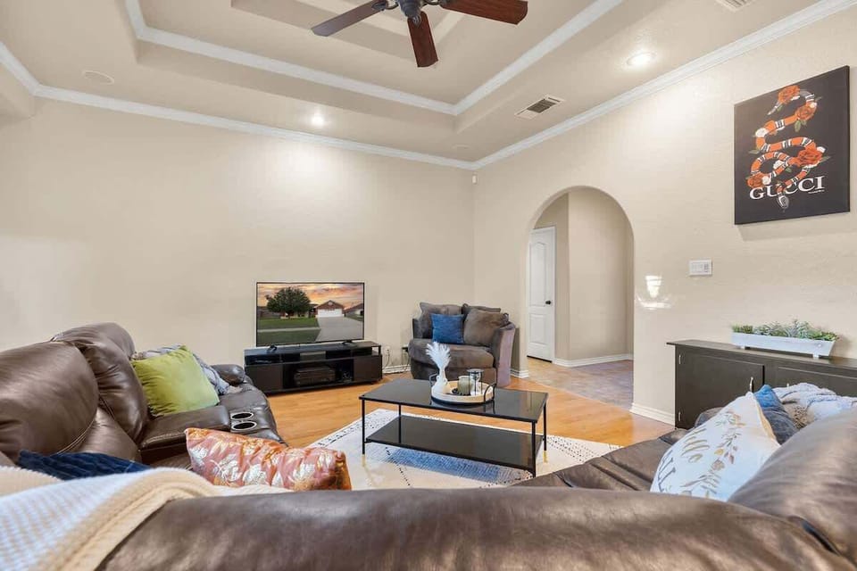 Large open concept living room with vaulted ceilings and 55" flat screen smart tv.