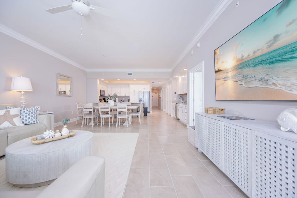 Unwind in this inviting living area, featuring a sectional, stylish decor, and a large TV