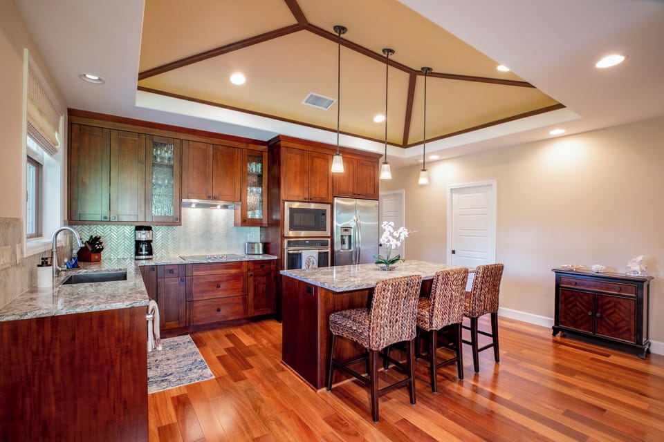 Gather for breakfast or happy hour at the kitchen island, a central hub for food and conversation.