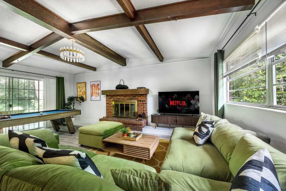 Living room with smart TV, fireplace, and pool table