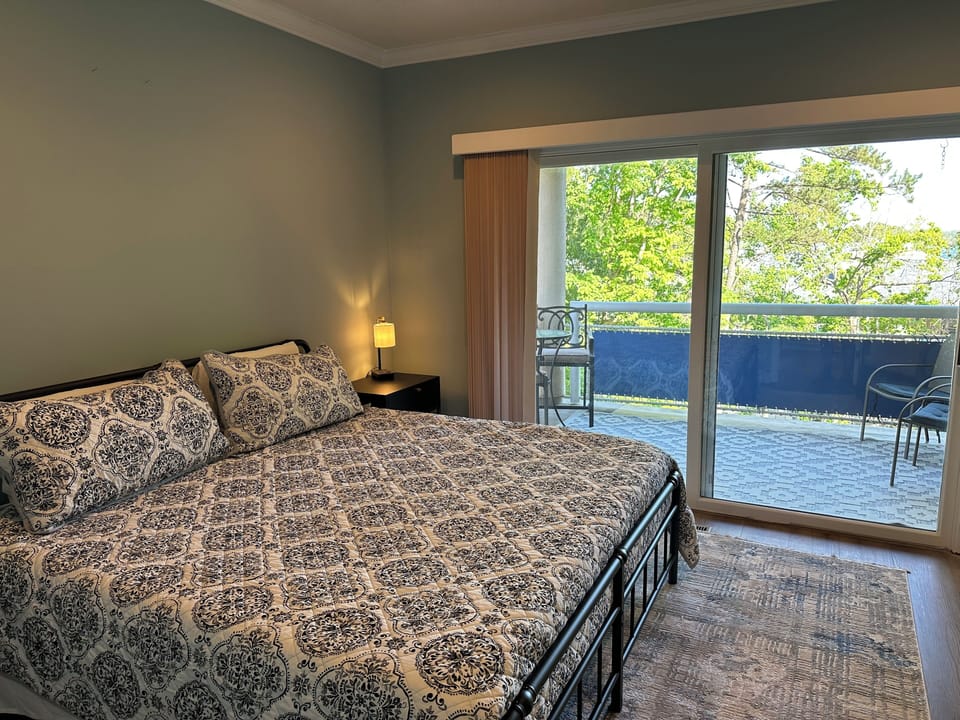 Bedroom 1: King bed with balcony access