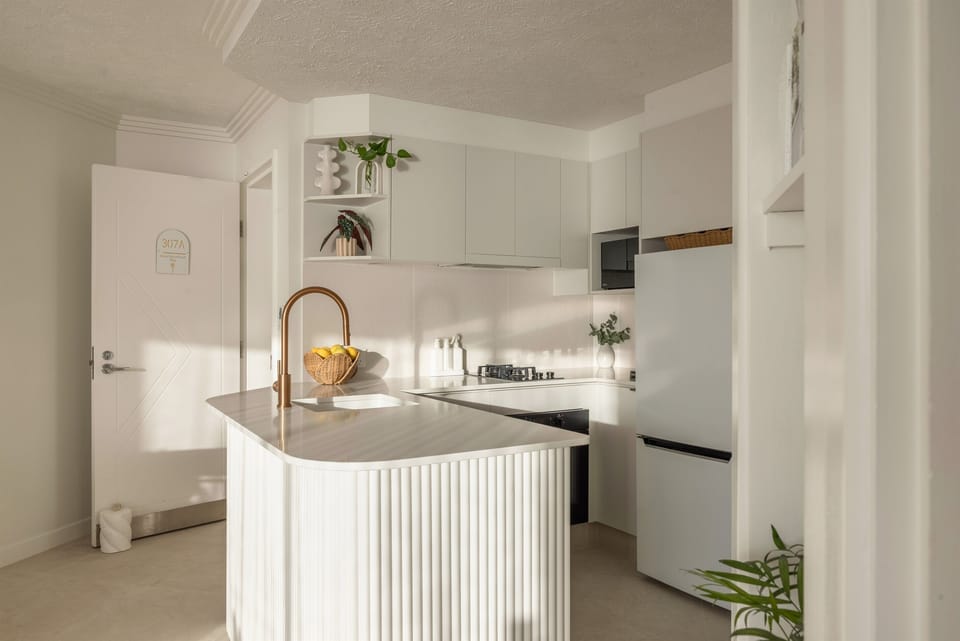 Newly renovated full kitchen featuring premium brushed-copper tapware, modern appliances (fridge, oven, microwave & cooktop) and all the essentials for comfortable home-style cooking.