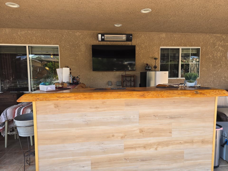 Outdoor bar, fridge, and smart TV.