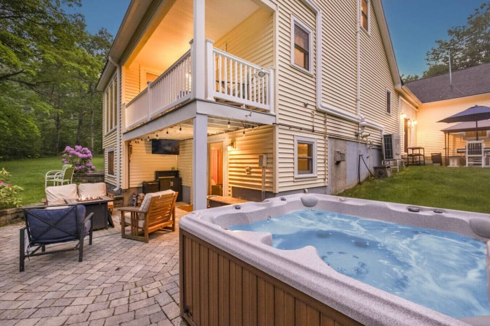 Private outdoor hot tub surrounded by peaceful woods, with comfortable seating and space to relax after a day on the lake.