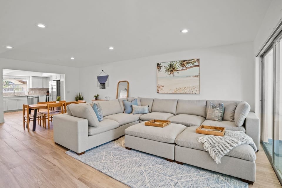 Unwind in comfort in our Unit 1 living room! 🛋️ Relax on the large sectional and enjoy a movie on the 65-inch TV after a long, wonderful day at the beach. 🎬🏖️