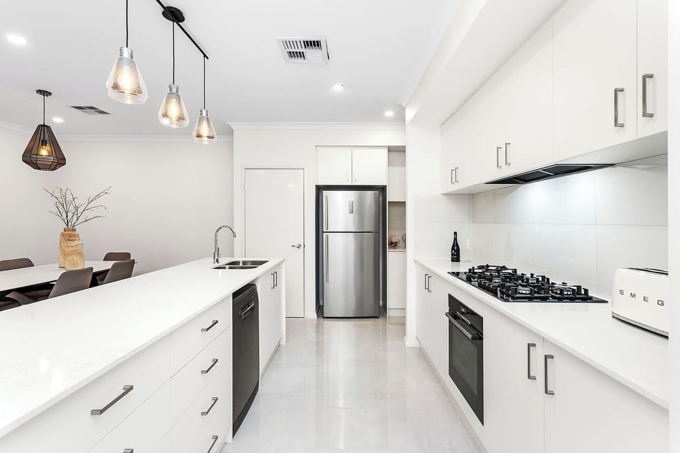 Kitchen with sink, 5 hob stove, oven, fridge, toaster, kettle and all utensils