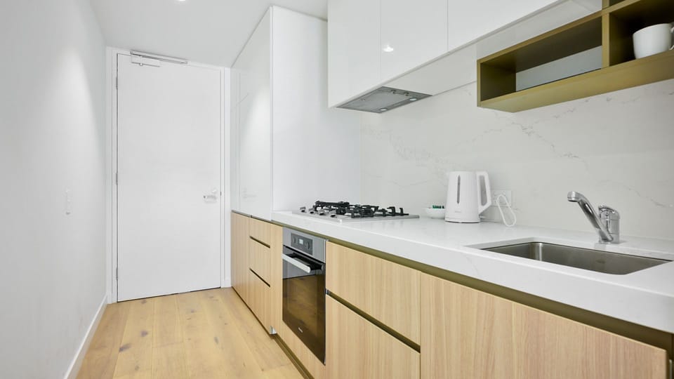 The modern kitchen includes a dishwasher and coffee plunger—ideal for meal prep or your morning coffee.