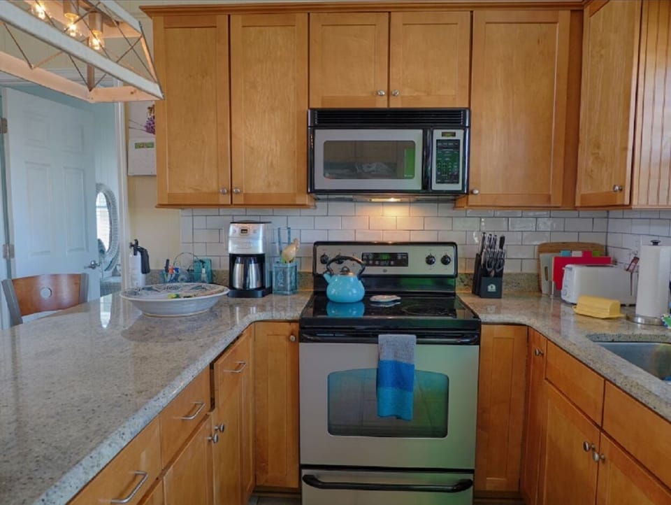 Kitchen has stainless steel appliances and granite counter tops.