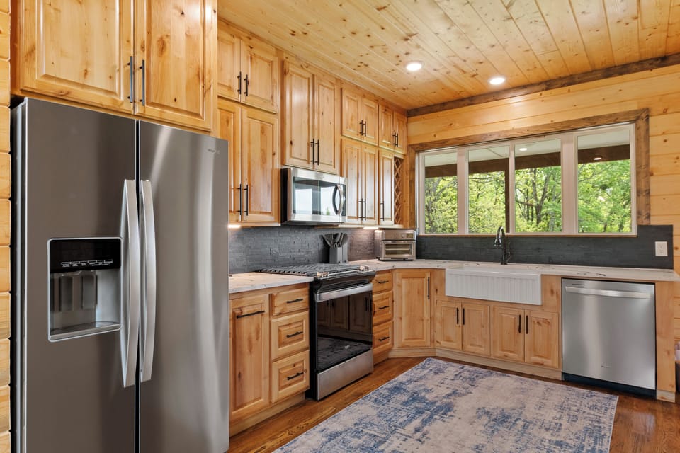 Kitchen; Refrigerator, microwave, gas range, dishwasher, air fryer, & farm sink.