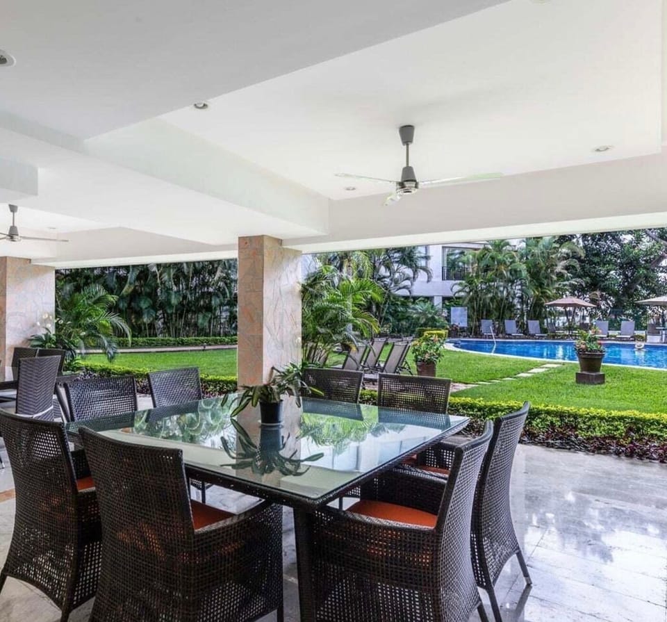 Shared common area near pool. Has tables & chairs, couches, sink and fridge