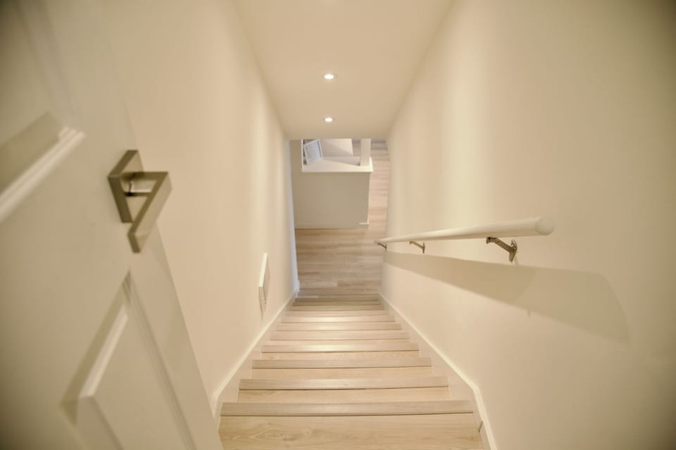 Staircase to downstairs living room, bedroom, bathroom, and laundry room
