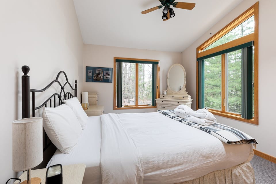 Includes a white dresser with an oval mirror and a nightstand with a lamp.