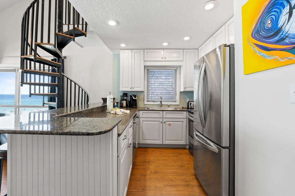 Fully equipped with stainless appliances, coffee bar, and granite counters – all just steps from ocean views.
