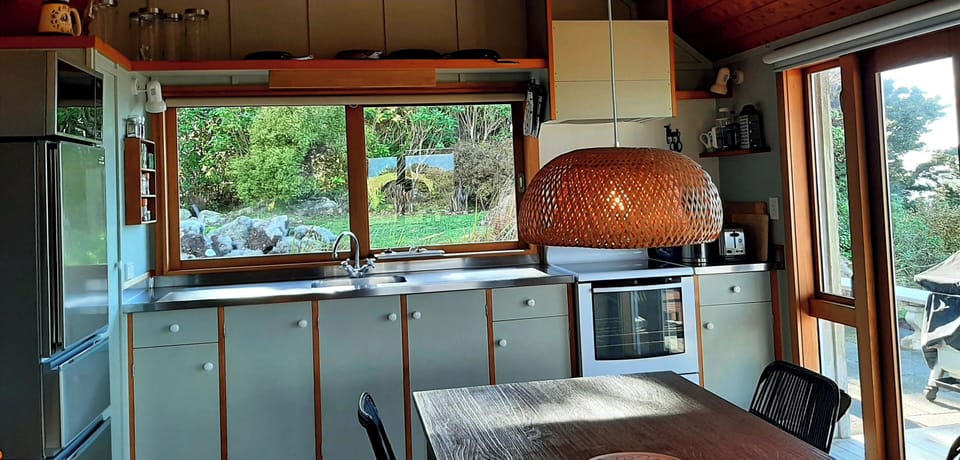Simple in line kitchen bench with everything you need. Opens directly to deck