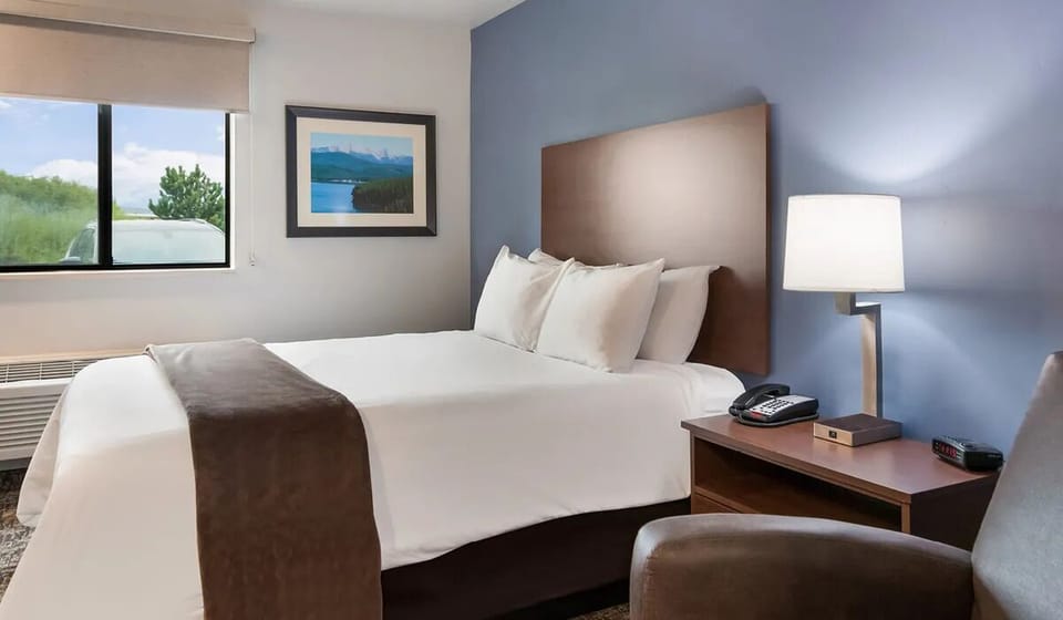 Unwind in a bright king room with cozy reading chair.