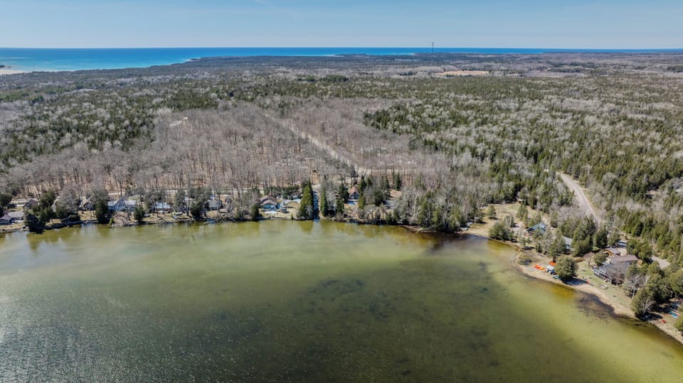 Scenic lakeside community with beautiful wooded landscapes and clear waters. A hidden gem for peaceful cottage stays near sandy beaches and nature trails!