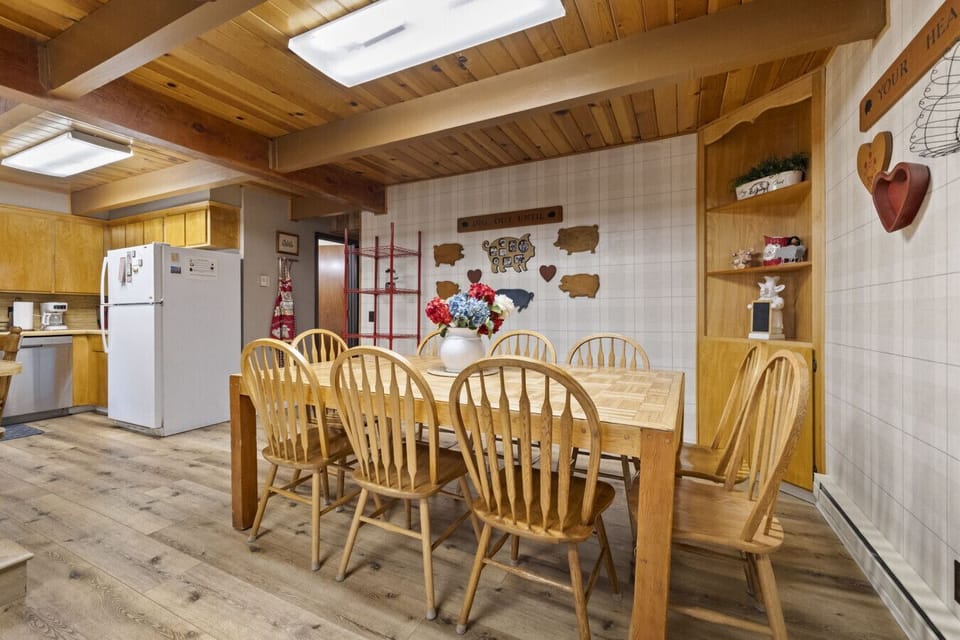 Gather around the hearty farmhouse table at The Laughing Pig—seating for ten and made for unforgettable meals and laughter-filled nights.