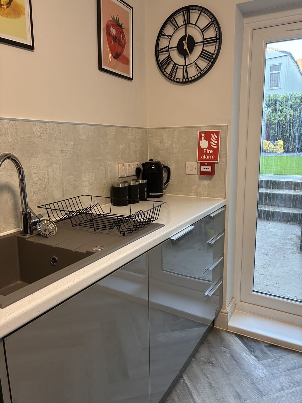 Kitchen with Hob, Oven, Toaster, Kettle, Microwave, Airfryer, Fridge Freezer and Dishwasher - leading to Garden