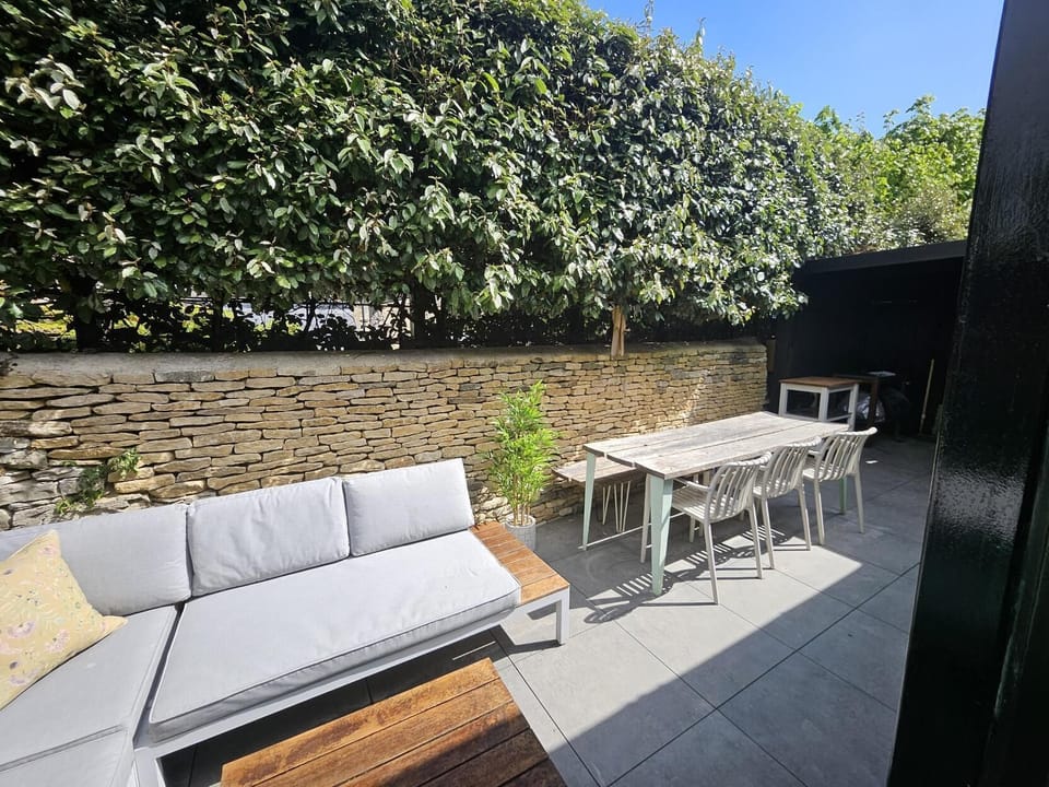 The back terrace area - complete with couch, dining table & chairs & gas BBQ. 