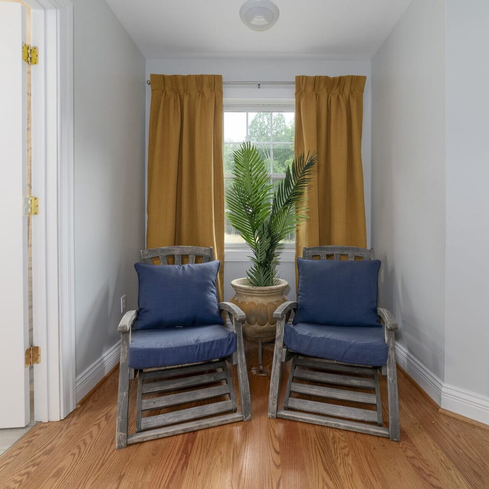 Primary bedroom`s lounging nook adjacent to the en suite bathroom entrance.