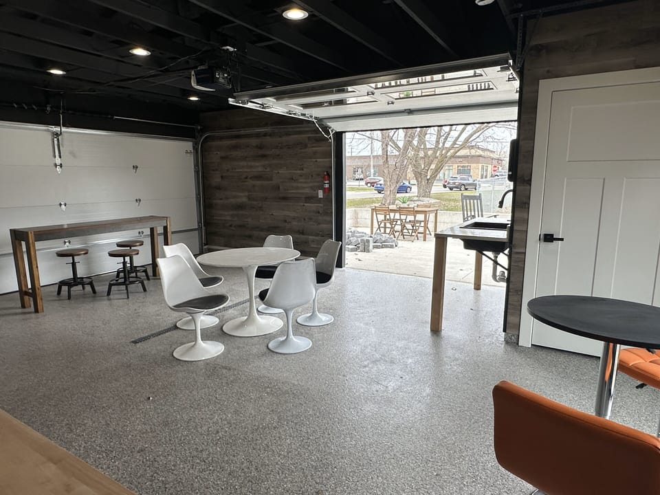 Indoor/outdoor space for tailgate or BBQ! Plus a half bath behind that door.