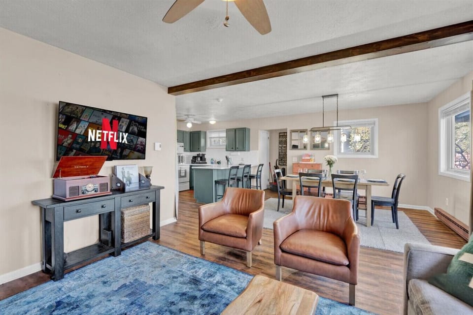 Open-concept living at its best—gather, dine, and unwind with plenty of space for everyone in the cozy living room, dining area, and fully equipped kitchen.