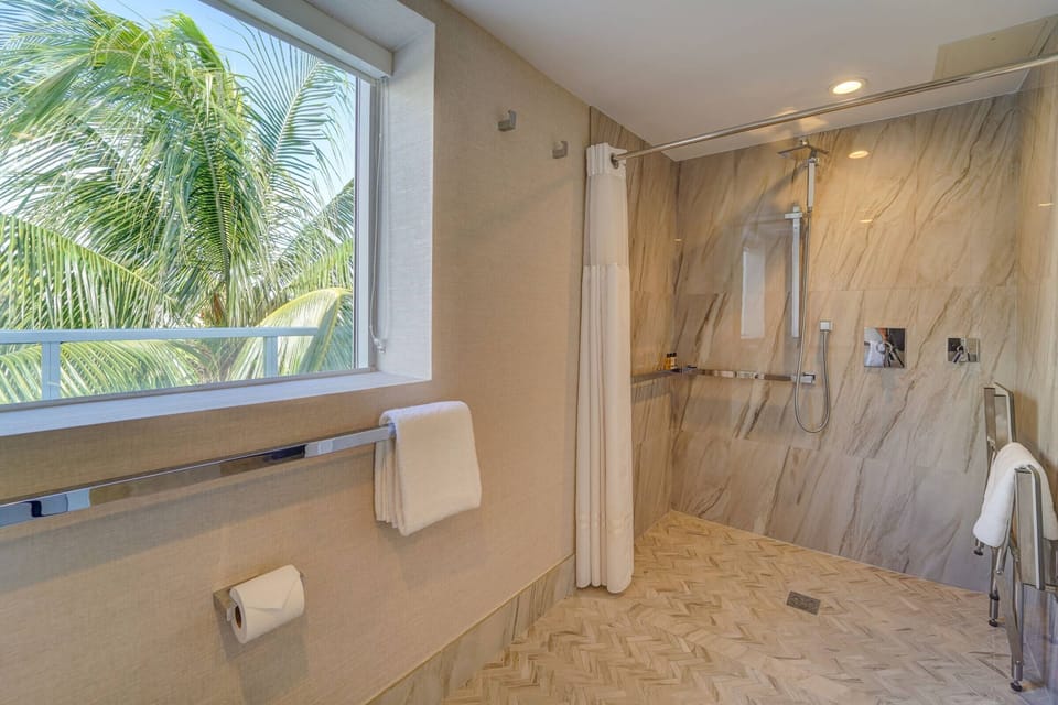 Rinse off in the oversized walk-in shower with luxe tile.