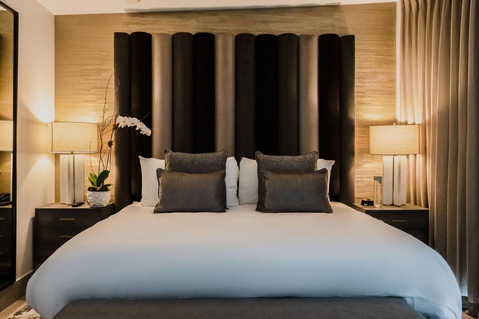 Sink into plush pillows under warm, hotel-style lighting.