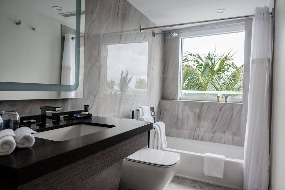 Refresh in a spa-like bath with marble surrounds and daylight.