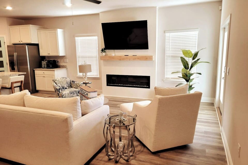 Cozy centered sleeper sofa in the heart of the open living area—extra beds + ultimate relaxation for family beach getaways.