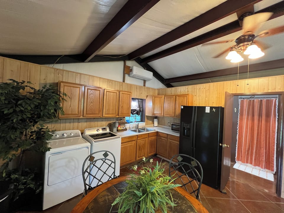 Kitchenette and showing the bathroom door open & shower curtain