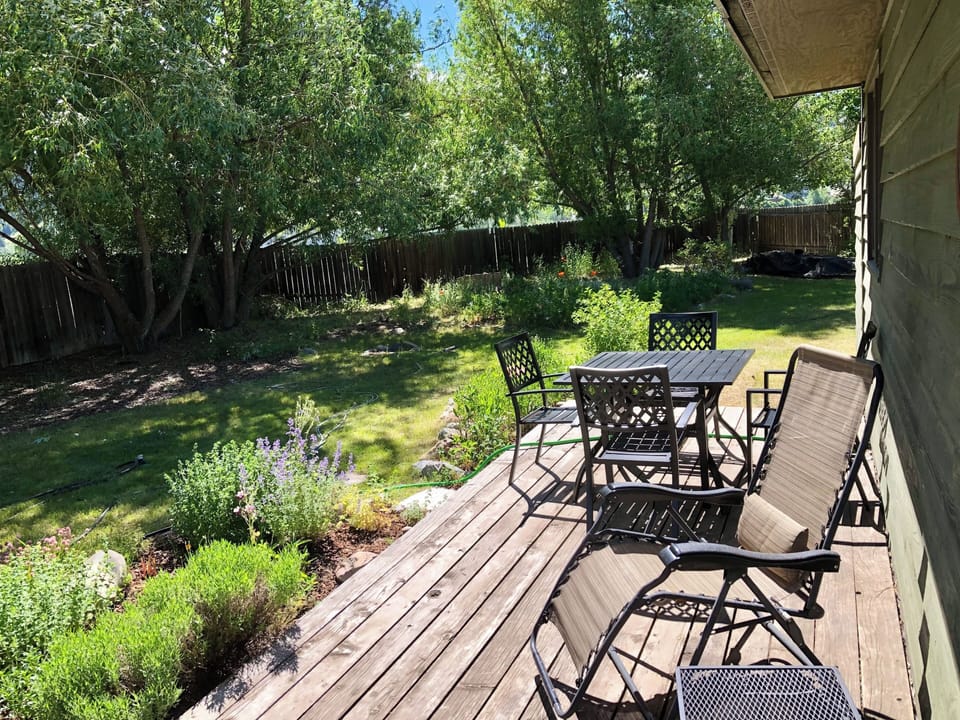 Back Deck with mature gardens full of poppies, lupine, lavender & kitchen herbs.