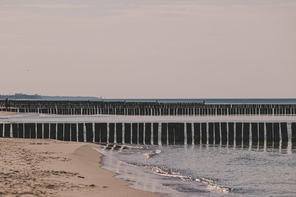 Wide sandy beach with a pier – just a 10-minute walk from the apartment, perfect for morning runs or family sunbathing.