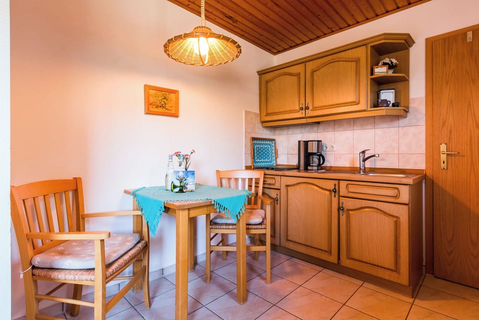 Kitchen with wooden furniture and small table