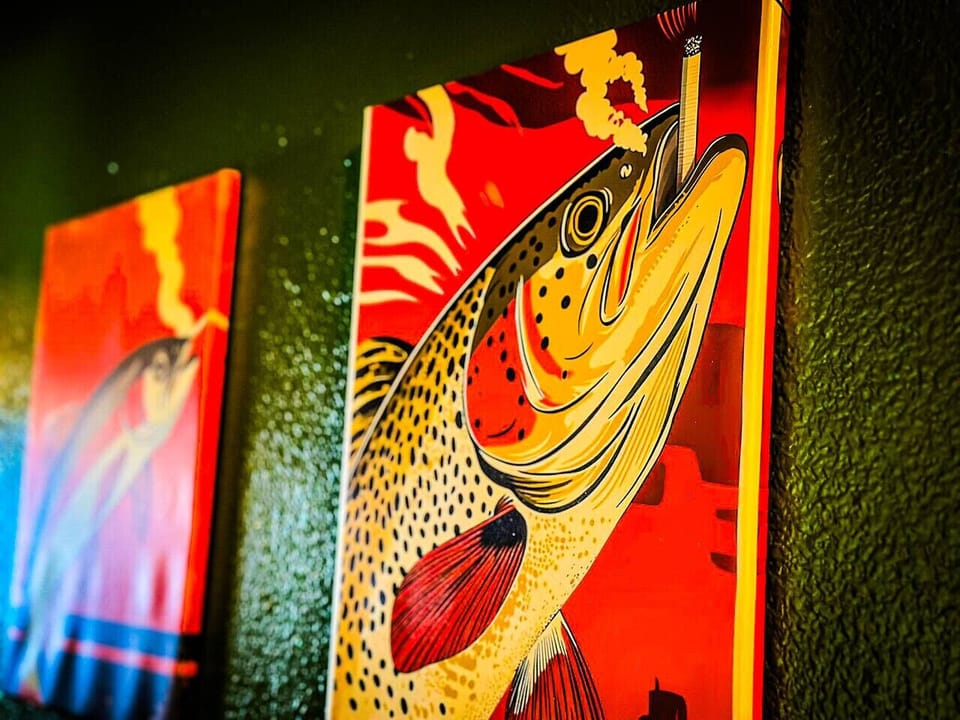Bold fishing-themed wall art bringing vibrant color and lakehouse character