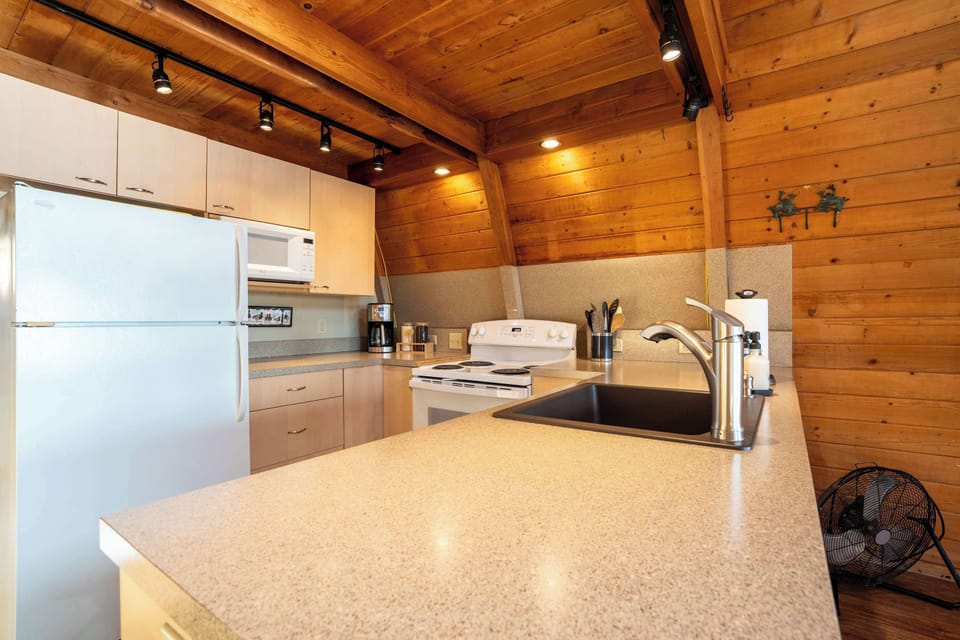 The fully equipped kitchen has everything you need for meals at the lake.