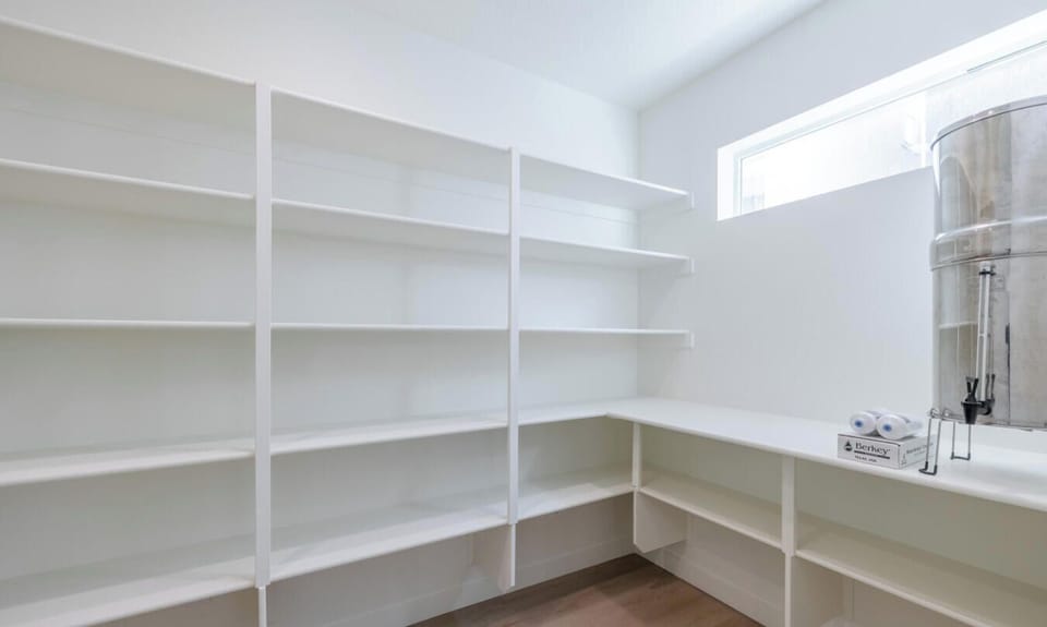 Walk-in closet with extensive built-in shelving and natural light